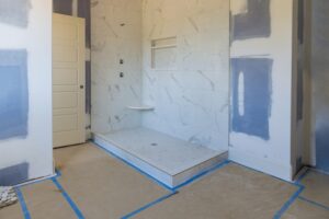 Renovation construction of master bathroom with new under construction bathroom interior drywall ready for tile in new luxury home
